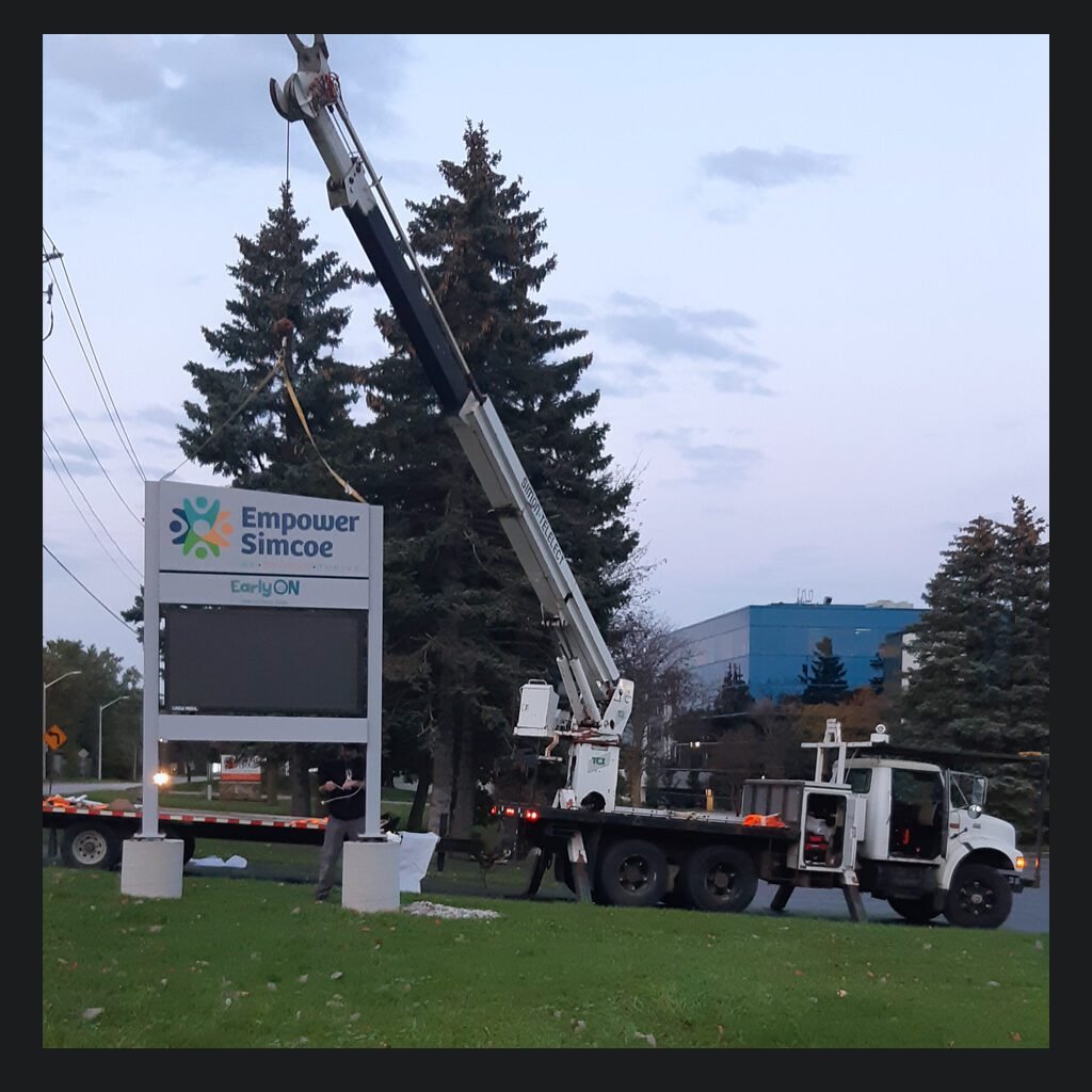 Pylon ground sign crane truck